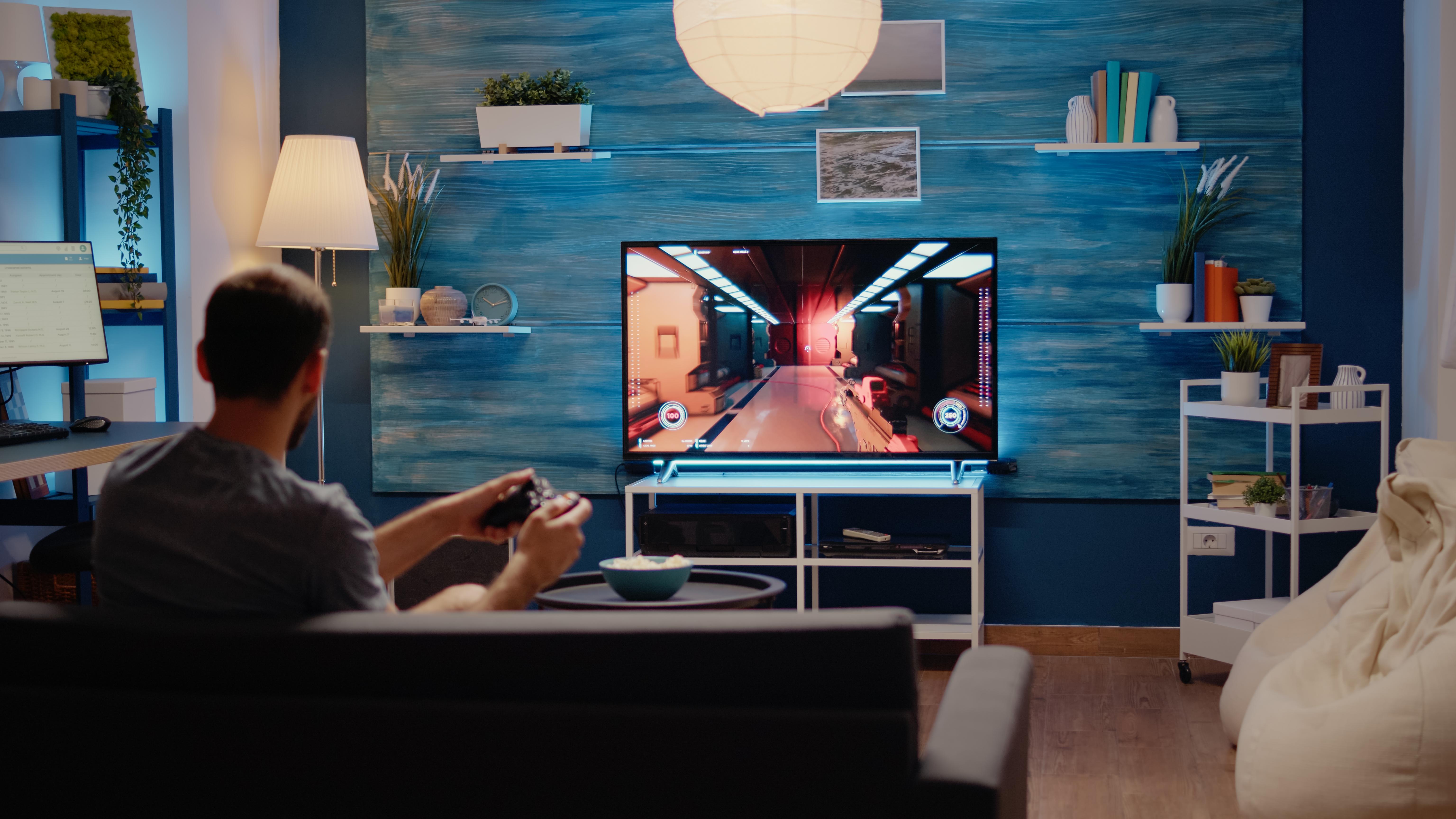 caucasian-man-playing-action-games-tv-console.jpg