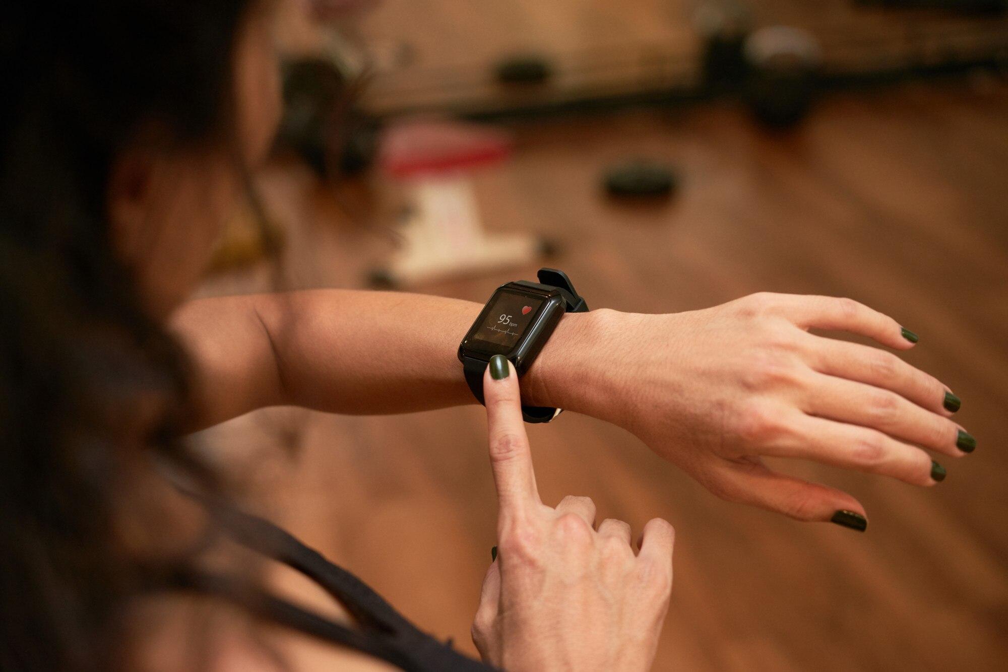 top-view-unrecognizable-woman-checking-health-app-her-wrist-gadget-1098-18985.jpg